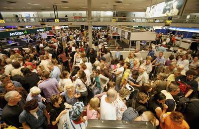 Passengers wait for their flights at Terminal One on August 10, 2006. London Airports have been thrown into chaos as airport security was raised to critical after a terrorist plot to blow up planes in mid-flight from the UK to the US was disrupted by police.