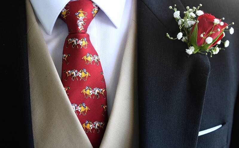 A horse-themed tie is worn by a race-goer. EPA
