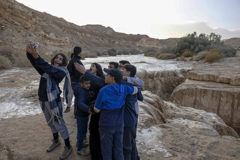 Israeli children enjoy the deluge, but in Beersheba a man had to be rescued from fast-flowing floodwaters
