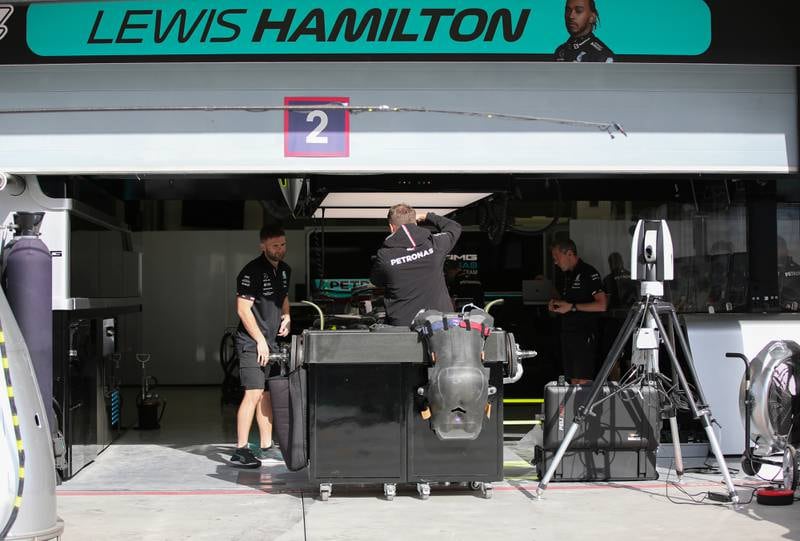 Mechanics works on Hamilton's car ahead of the first race in Bahrain. EPA
