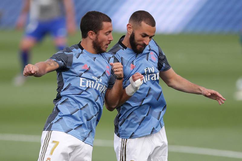 Eden Hazard bumps shoulders with Karim Benzema as they warm up. Getty