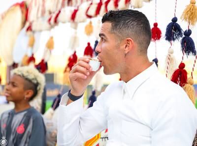 Al Nassr's Cristiano Ronaldo drinking Saudi coffee during Saudi Arabia's Founding Day celebrations. Reuters