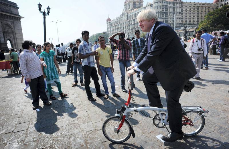 London mayor Boris Johnson rides a bicycle around the Gate of India in Mumbai, after meeting business leaders at the Bombay Stock Exchange, as part of a week long tour of India where he is trying to persuade Indian businesses to invest in London.   (Photo by Stefan Rousseau/PA Images via Getty Images)
