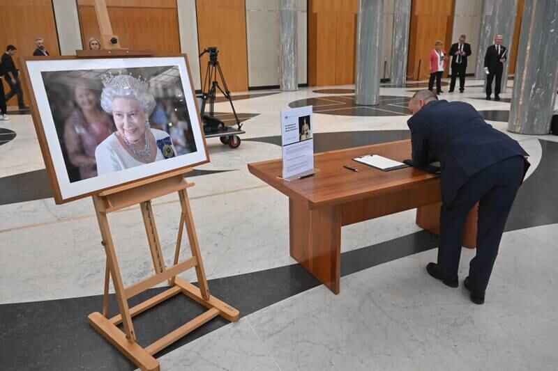 A member of the public signs the condolence book at Parliament House in Canberra, Australia. EPA