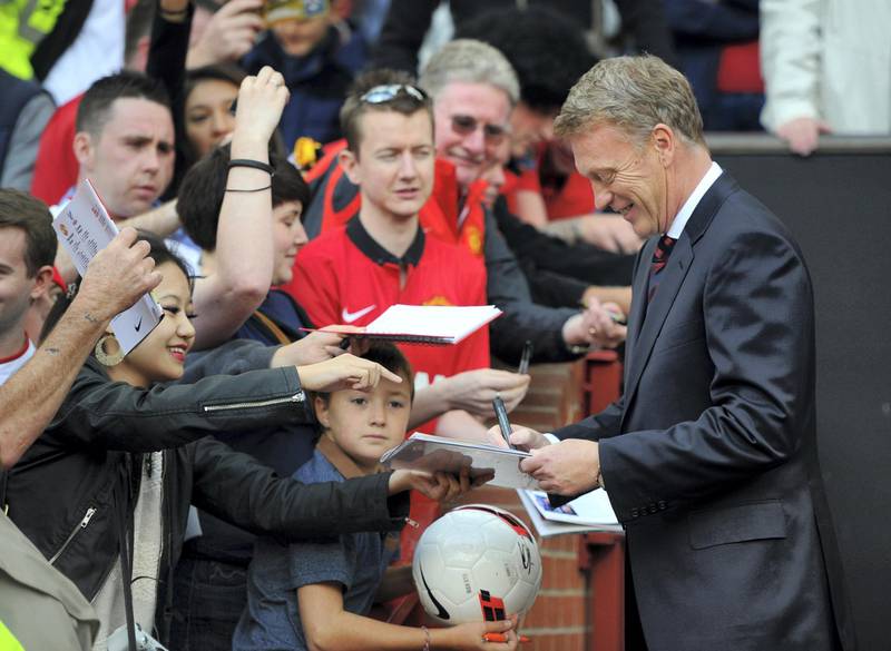 MANCHESTER, ENGLAND - SEPTEMBER 14:  David Moyes manager of Manchester United signs autographs prior to the Barclays Premier League match between Manchester United and Crystal Palace at Old Trafford on September 14, 2013 in Manchester, England.  (Photo by Michael Regan/Getty Images)