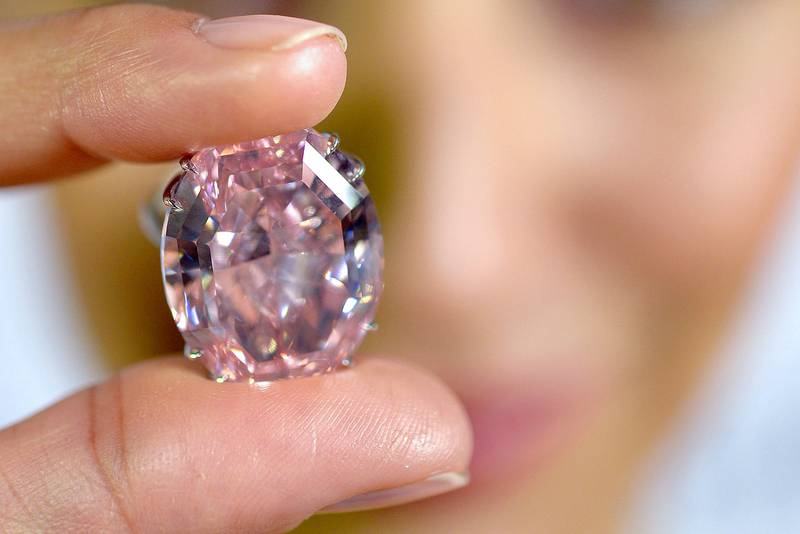A Sotheby's employee shows The Pink Star diamond weighing 59.6 carats, the most valuable diamond ever to be sold at auction. AP