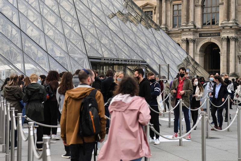 People queue outside the Louvre Museum in Paris, as museums reopen in France today as part of an easing of the nationwide lockdown. AFP