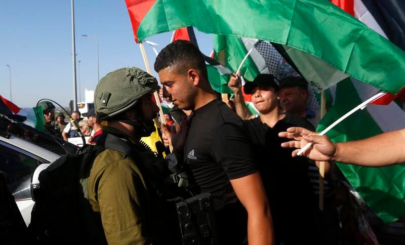 Palestinians face off with Israeli soldiers during a protest in Azoun, near the West Bank city of Qalqilya, in June. EPA