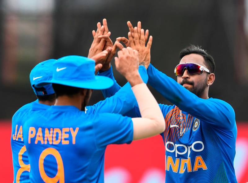 Krunal Pandya (R) of India celebrates the dismissal of Nicholas Pooran of West Indies during the 2nd T20i match between West Indies and India at Central Broward Regional Park Stadium in Lauderhill, Florida, on August 4, 2019. / AFP / Randy Brooks
