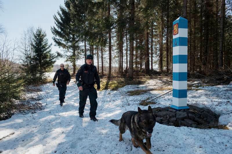Finnish guards Tuomas Rama and Marko Hytti with German shepherd Leif near the border. Getty Images