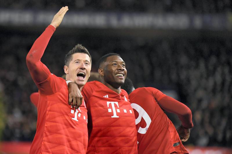 LONDON, ENGLAND - FEBRUARY 25: Robert Lewandowski of Bayern Munich celebrates with David Alaba after he scores his team's third goal during the UEFA Champions League round of 16 first leg match between Chelsea FC and FC Bayern Muenchen at Stamford Bridge on February 25, 2020 in London, United Kingdom. (Photo by Mike Hewitt/Getty Images)