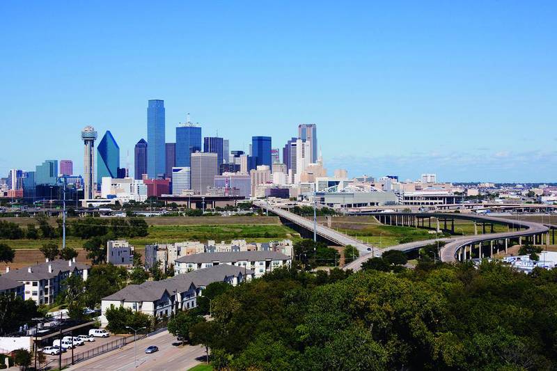 Downtown Dallas, as seen across the Trinity River, allows visitors to explore a real Texan city without encountering too many tourist traps. Getty Images