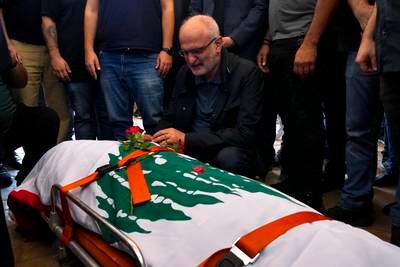 Member of Lebanese parliament Ali Hassan Khalil mourns the body of Reuters videographer Issam Abdallah, who was killed by Israeli shelling, during his funeral in Khiam, southern Lebanon. AP Photo