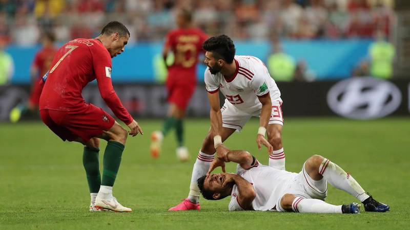 Portugal's Cristiano Ronaldo, left, reacts as Iran's Morteza Pouraliganji lies injured on the floor. Ivan Alvarado / Reuters