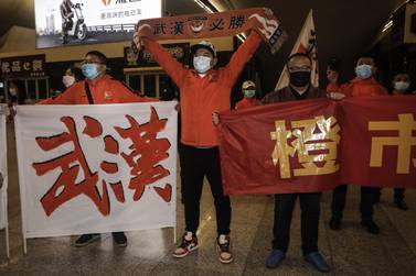 Supporters of Wuhan Zall welcome the team as they arrive arrive at Wuhan railway station. They left on January 5 for training in Guangzhou, and then spent 104 days in exile after the outbreak of coronavirus. Getty