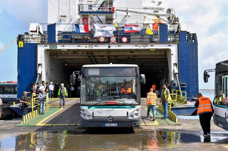 Buses donated by the French government are unloaded at the Port of Beirut. The first batch consists of 50 modern vehicles sent to help develop Lebanon's public transport plan. All photos: EPA