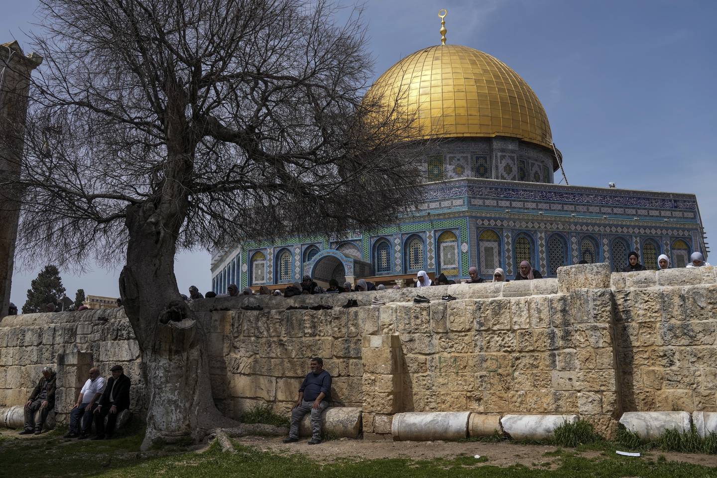 Muslim worshippers gather for Friday prayers next to the Dome of the Rock Mosque in the Al Aqsa Mosque compound in Jerusalem's old city.  AP Photo