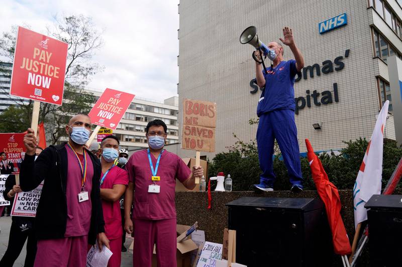 Workers from the National Health Service (NHS) demonstrate outside St Thomas Hospital, Central London, Britain.  EPA