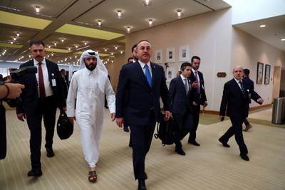 Turkish Foreign Minister Mevlut Cavusoglu walks ahead of the signing of an agreement between members of Afghanistan's Taliban delegation and the US government in Doha, Qatar. Reuters