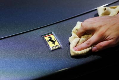 An employee polishes the front of a Ferrari car. Enthusiasts expect Ferrari to showcase its 488 Spider at the Frankfurt International Motor Show. Kai Pfaffenbach / Reuters