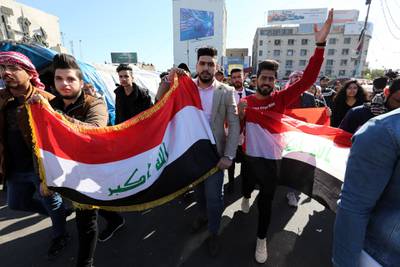 Iraqi protesters chant slogans and carry the Iraqi national flag during ongoing anti-government protests at the Al Tahrir square in central Baghdad.  EPA