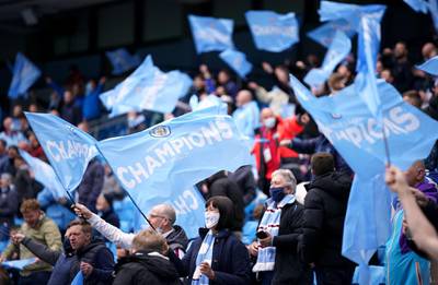 Manchester City fans wave flags during the match against Everton at the Etihad Stadium. PA