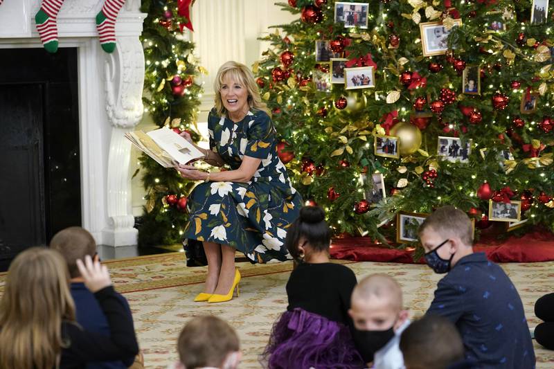 Jill Biden reads a book co-written with granddaughter Natalie, 'Don't Forget, God Bless Our Troops', to a group of children in the White House. AP