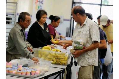 People pick up lunch in the soup kitchen of the St Francis Centre in Los Angeles. Kevork Djansezian / Getty