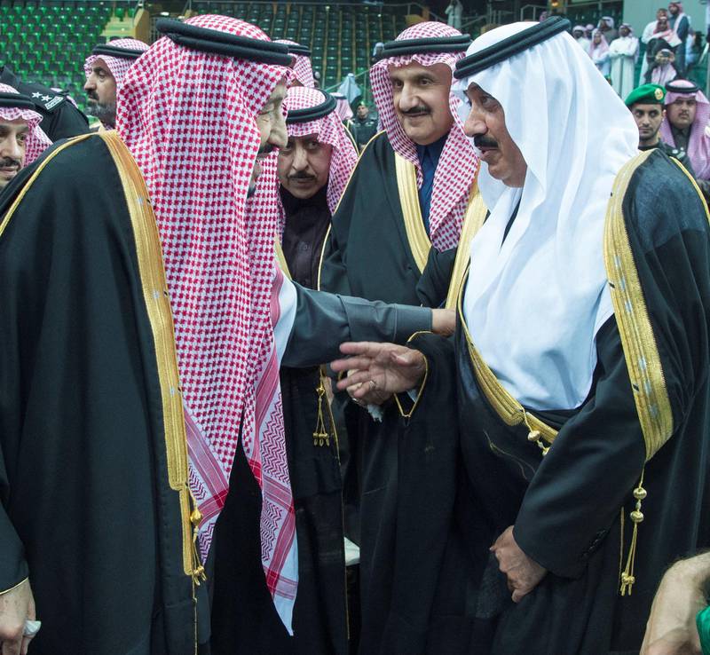 Saudi Arabia's Prince Miteb bin Abdullah talks with King Salman of Saudi Arabia during at the cultural festival in Riyadh. Prince Miteb was temporarily detained in an anti-corruption clampdown and was released after reaching an undisclosed settlement with authorities. Bandar Algaloud / Courtesy of Saudi Royal Court / Reuters