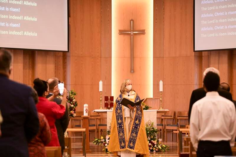 Rev Christine Trainor conducts the first Easter Sunday Mass at St. Andrew's in Abu Dhabi since pandemic restrictions were relaxed. Khushnum Bhandari / The National
