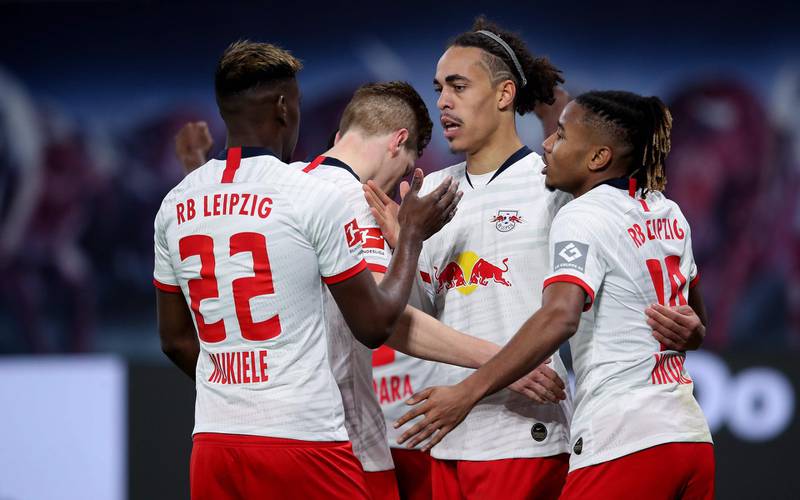 Leipzig's Danish forward Yussuf Poulsen (2nd R) celebrates after scoring the 3-1 lead with Leipzig's French defender Nordi Mukiele (L), Leipzig's German defender Marcel Halstenberg (2nd L) and Leipzig's French midfielder Christopher Nkunku (R) during the German first division Bundesliga football match RB Leipzig v FC Augsburg in Leipzig, eastern Germany, on December 21, 2019. DFL REGULATIONS PROHIBIT ANY USE OF PHOTOGRAPHS AS IMAGE SEQUENCES AND/OR QUASI-VIDEO 
 / AFP / Ronny Hartmann / DFL REGULATIONS PROHIBIT ANY USE OF PHOTOGRAPHS AS IMAGE SEQUENCES AND/OR QUASI-VIDEO 
