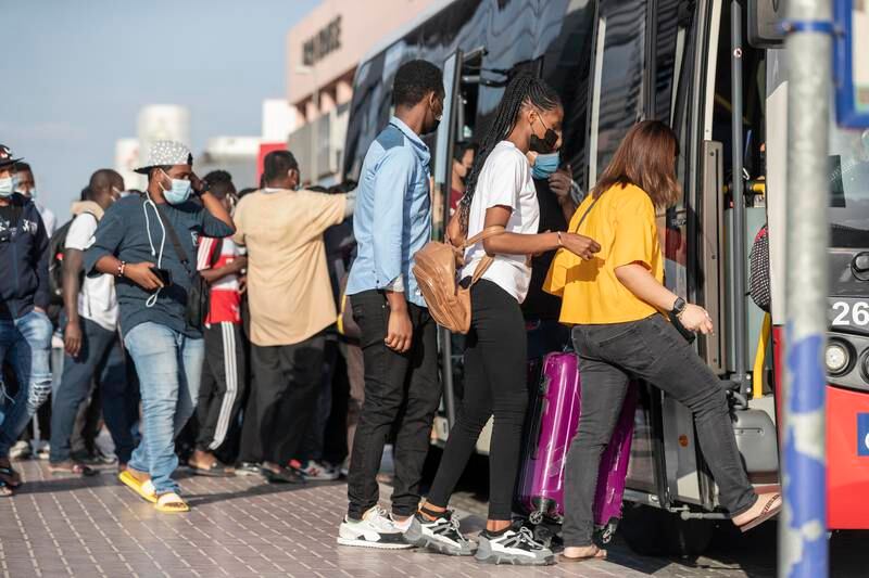 Passengers board a bus at Al Safa Metro station. Antonie Robertson / The National