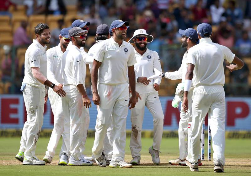 Indian players celebrate the dismissal of Afghanistan's Mohammad Nabi during the second day of their one-off cricket test match in Bangalore, India, Friday, June 15, 2018. (AP Photo/Aijaz Rahi)