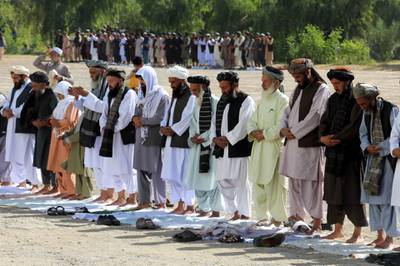 Afghans offer congregational prayers during the holy festival of Eid Al Adha, in Kandahar, Afghanistan.  EPA