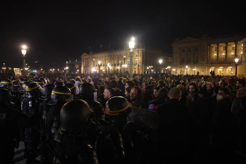 French police face protesters at the Place de la Concorde in Paris after the pensions reform was pushed through on March 16. AFP
