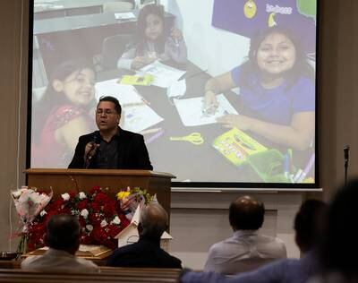Pastor Carlos Contreras preaches to his congregation as photos of some of the children killed in the mass shooting at Robb Elementary flash on the screen at Primera Iglesia Bautista, in Uvalde. Reuters