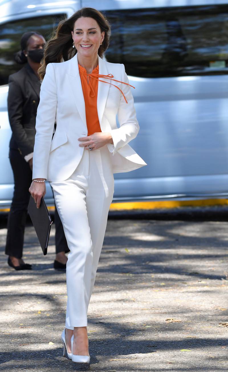 The royal wore a white Alexander McQueen suit with an orange Ridley London blouse in Kingston, Jamaica, during the official tour of the Caribbean on March 23, 2022. Reuters 