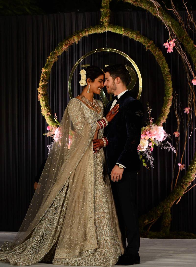 Newlyweds Priyanka Chopra, 36, and Nick Jonas, 26, pose for a photograph during a reception at a hotel in New Delhi on December 4, 2018. Photo: AFP