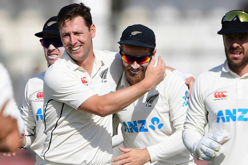 New Zealand's Matt Henry, second left, celebrates with teammate Kane Williamson after taking the wicket of Pakistan's Abdullah Shafique during the second day of the second Test at the National Stadium in Karachi on Tuesday, January 3, 2023. AFP