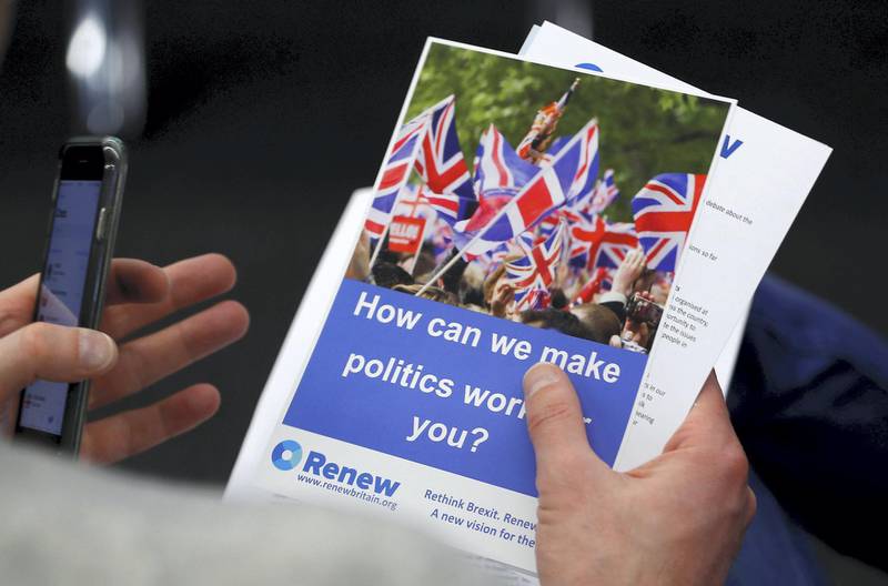 A journalist reads literature produced by the Renew party at press conference in London, Britain, February 19, 2018. REUTERS/Peter Nicholls - RC1AB6ED3390