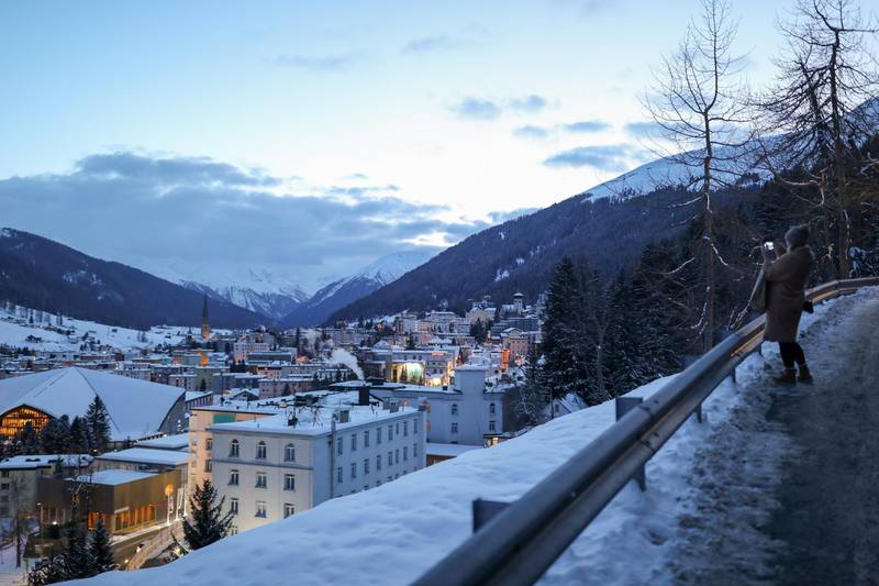 A pedestrian stops to take a smartphone photograph of Davos town ahead of the World Economic Forum (WEF) in Davos, Switzerland, on Sunday, Jan. 19, 2020. World leaders, influential executives, bankers and policy makers attend the 50th annual meeting of the World Economic Forum in Davos from Jan. 21 - 24. Photographer: Simon Dawson/Bloomberg