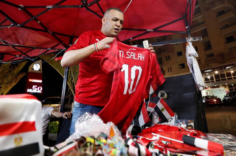 A trader holds up a replica shirt of Egypt's Mohamed Salah. Reuters