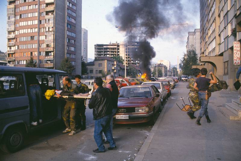 A casualty is helped into a van after a bombing in Sarajevo, circa 1992. Getty Images