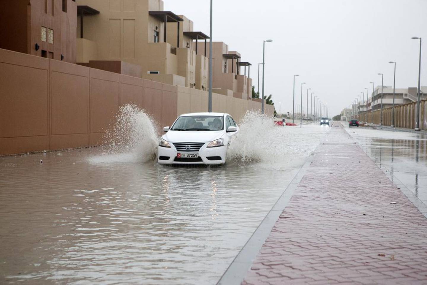 A car drives through a flooded street in Khalifa City of Abu Dhabi during the great storm of March 9, 2016. Christopher Pike / The National