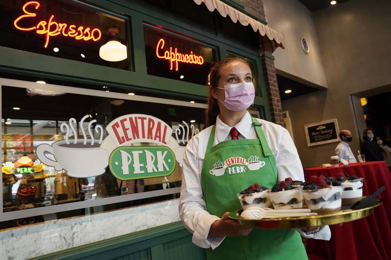 Madison Lakratz offers chocolate trifles to visitors to the 'Friends'-inspired Central Perk Cafe at the Warner Bros Studio Tour.