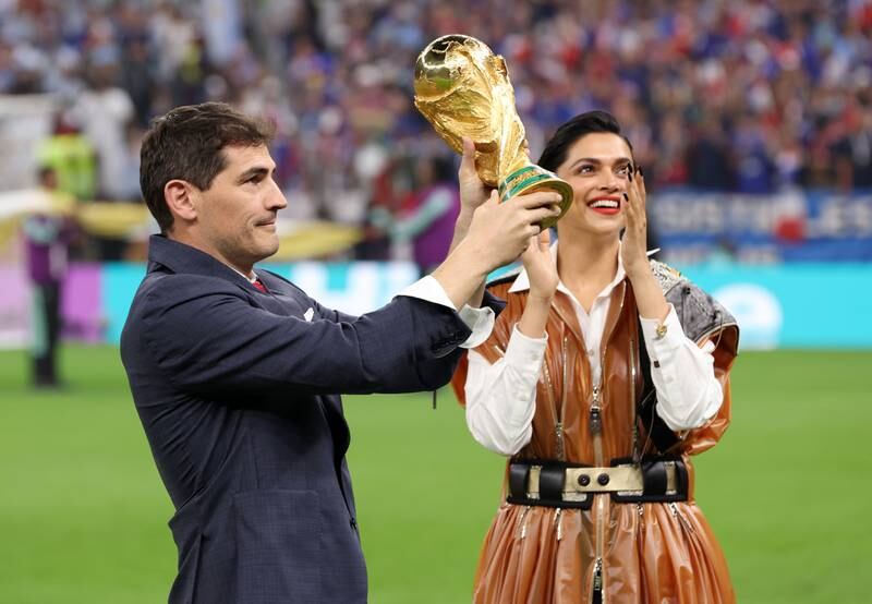 Spain great Iker Casillas and Bollywood star Deepika Padukone present the Fifa World Cup trophy prior to the final between Argentina and France at the Lusail Stadium on Sunday, December 18, 2022. Getty