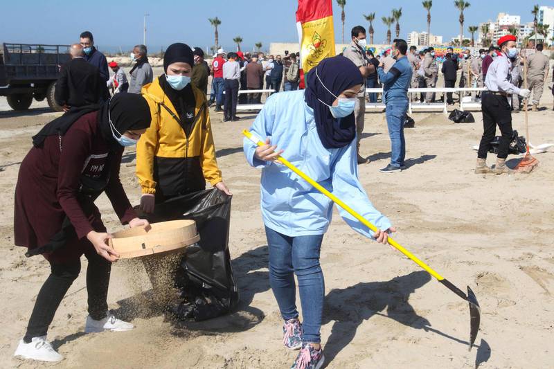 Young volunteers clean a contaminated beach in the southern Lebanese city of Tyre, following last week's offshore oil spill that drenched the northern Israeli coastline and reached parts of the neighbouring Lebanese beaches. AFP