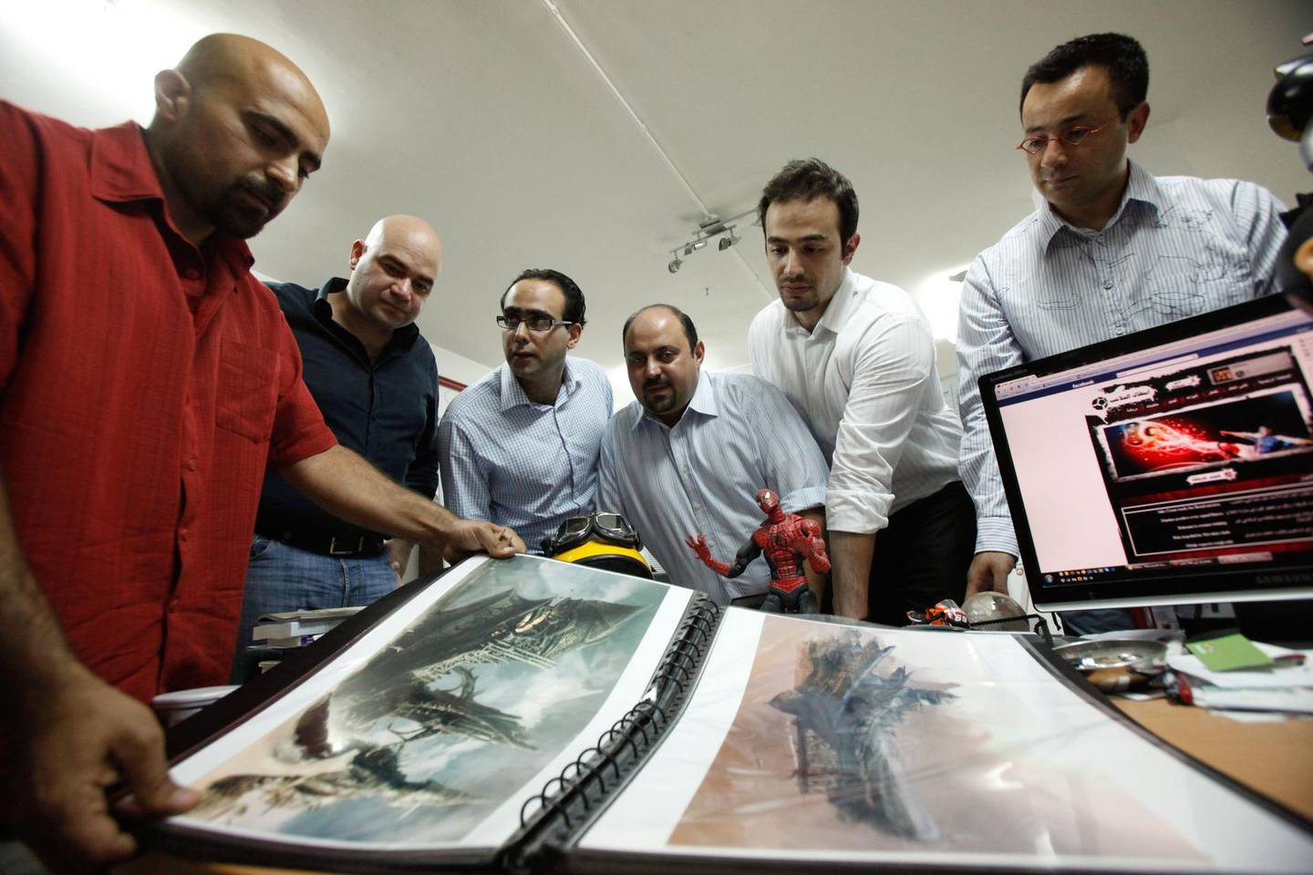 Suleiman Bakhit (L) discusses on his games paints with (from L to R): Afif Toukan, Mohammad Haj Hasan, Muhannad Ebwini, Suhaib Thiab and Nour Khrais, at his office in Amman, Jordan on June 08, 2010. (Salah Malkawi for The National)