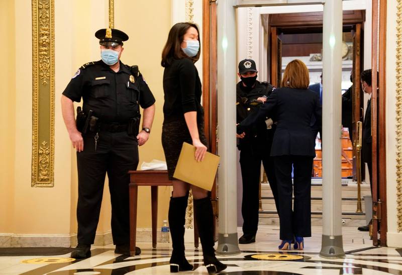 US House Speaker Nancy Pelosi walks through a new metal detector outside the House chamber as the House prepares to vote on a resolution demanding Vice President Pence and the cabinet remove President Trump from office, at the US Capitol in Washington DC, January 12, 2021. Reuters