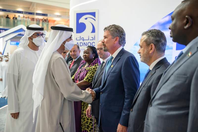 President Sheikh Mohamed greets an energy industry executive at the 2022 Abu Dhabi International Petroleum Exhibition and Conference at ADNEC. Hamad Al Kaabi / UAE Presidential Court